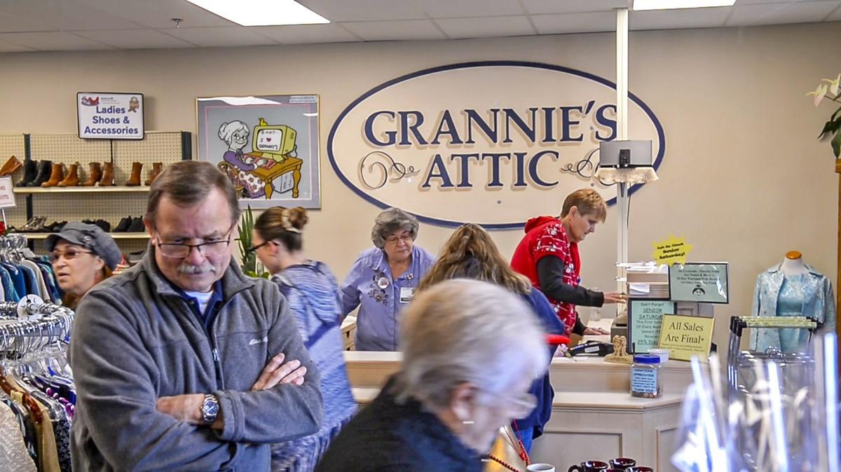 A flood of people look over the items at the grand re-opening of Grannies’ Attic Thrift Store in Puyallup, January 15, 2019. It has a new, larger location two blocks from the old one.