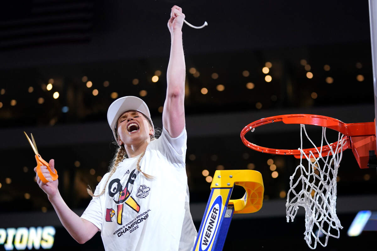 Louisville guard Hailey Van Lith (10) celebrates after help cut the net down after beating Michigan 62-50 in a college basketball game in the Elite 8 round of the NCAA women’s tournament Monday, March 28, 2022, in Wichita, Kan. (AP Photo/Jeff Roberson)