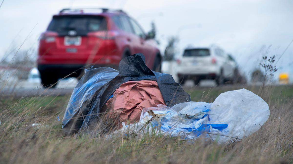 Trash lies along Interstate 5 through Tacoma, Washington, on Wednesday, Feb. 17, 2021.
