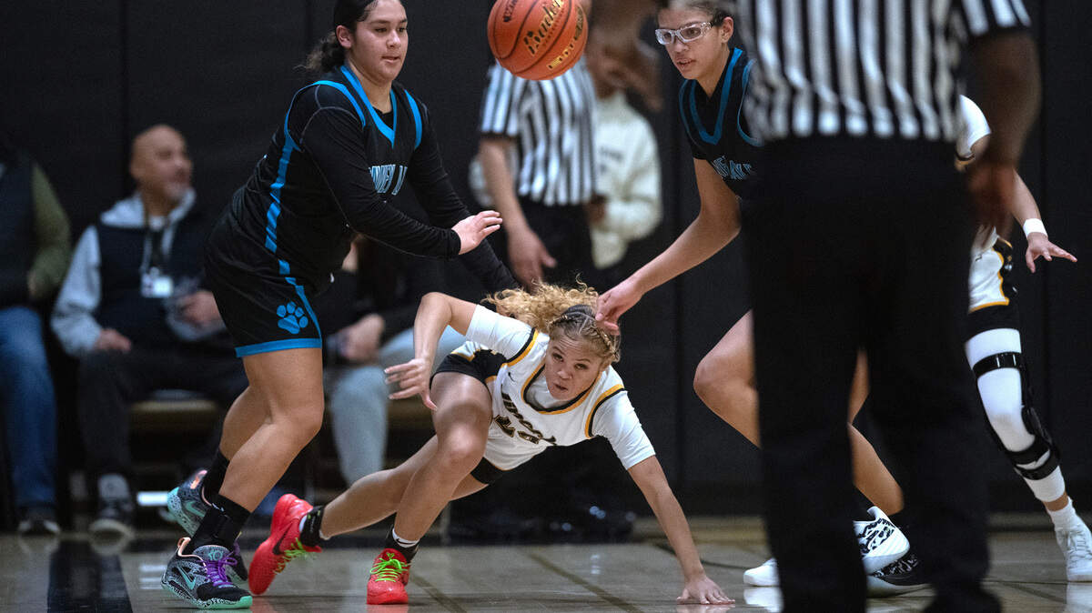 Lincoln’s Jaleigha Robinson hits the floor as she chases after a loose ball between Bonney Lake’s Isabelle Meki (left) and Azy Jackson during Friday night’s 3A PCL girls basketball game at Lincoln High School in Tacoma, Washington, Jan. 19, 2024. Bonney Lake won the game, 55-44.