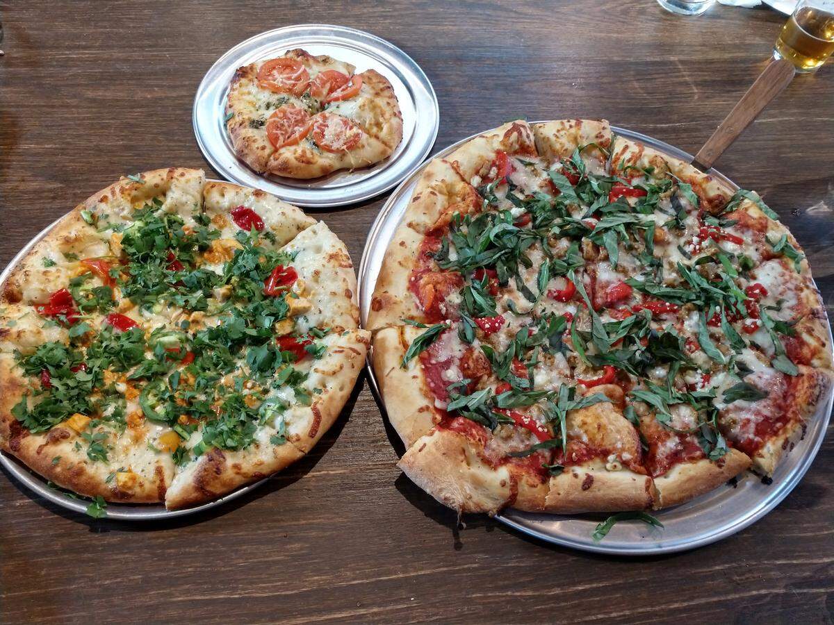 A trio of pies from Zeeks Pizza. At top is the Frog Belly Green. On the right is the large Spanish Steps. To the left is the medium sized Buffalo Soldier.
