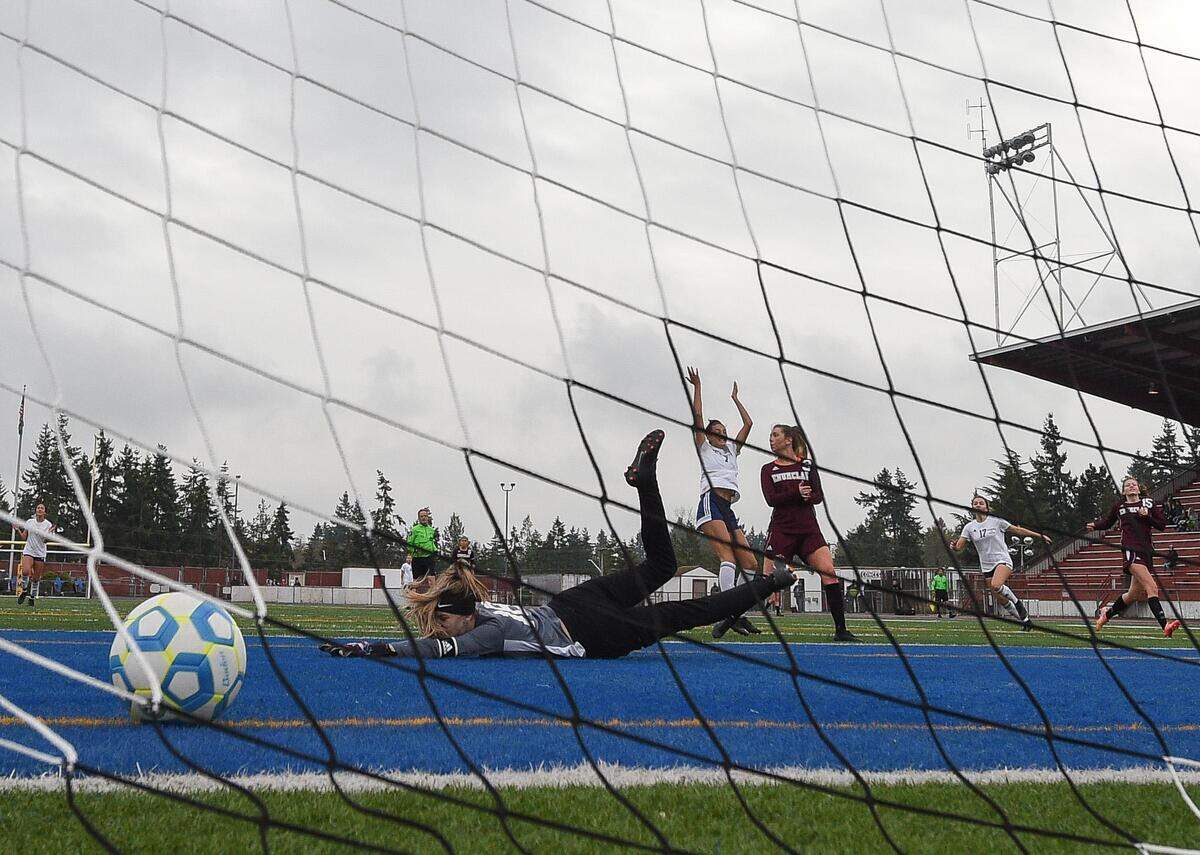 Bellarmine PrepÕs Acacia Judkins raises her arms in celebration as she gets the ball through EnumclawÕs Claire Lewis for a goal during the second half. Enumclaw played Bellarmine Prep in a soccer match at Memorial Stadium in Federal Way, Wash., on Saturday, Nov. 9, 2019.