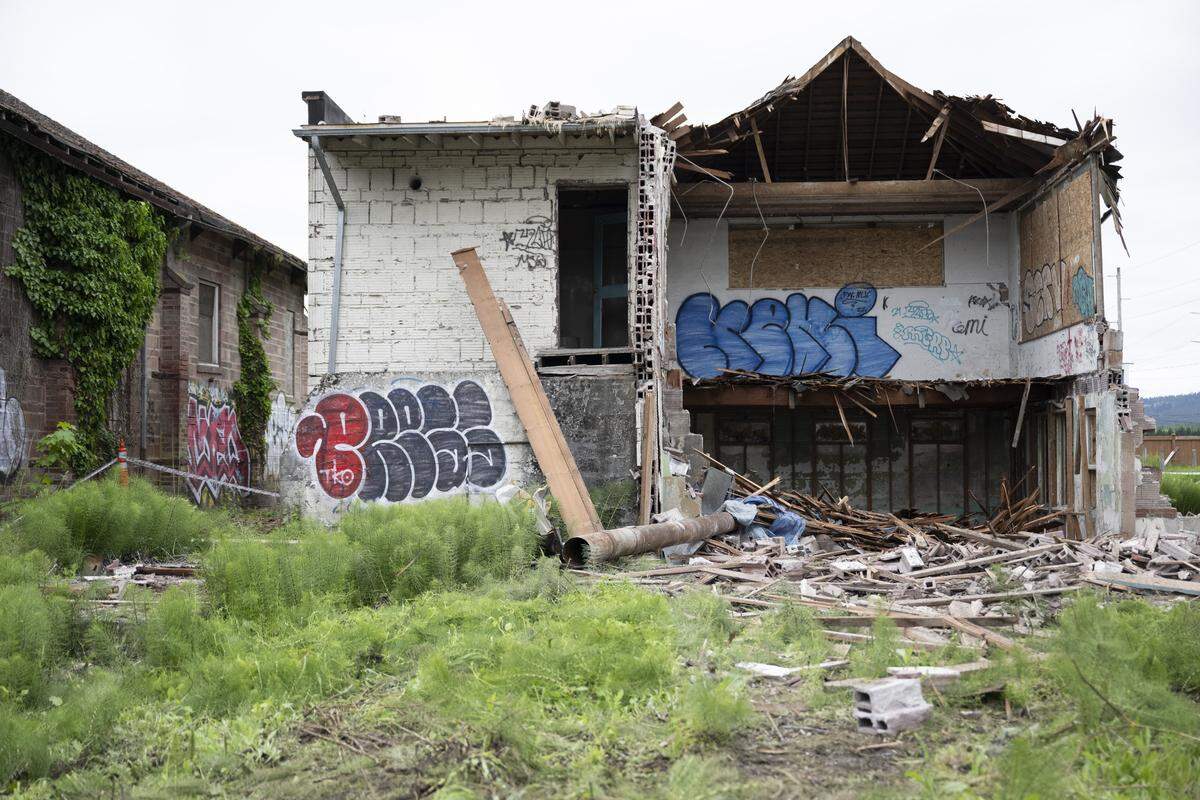 The historic Alderton School building stands halfway demolished on Tuesday, May 19, 2026, after an order was issued to stop the demolition.