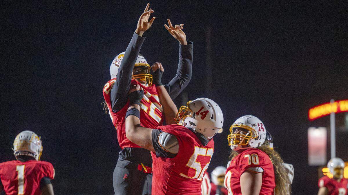 Mount Tahoma running back Keshawn Hines (22) is celebrated by Mount Tahoma tackle Andrew Savaiinaea (52) for Hines’ touchdown against Lincoln on Saturday, Nov. 22, 2025, in Tacoma, Wash.