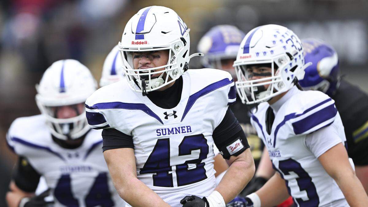 Sumner inside linebacker Mika Petaia (42) reacts to the stop against Puyallup running back Malcolm Akuffo (6) during the first half of the 4A state semifinal game at Sparks Stadium, on Saturday, Nov. 29, 2025 in Puyallup, Wash.