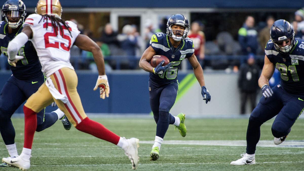 Seattle receiver Tyler Lockett looks for running room on a jet sweep in the second half. 49ers cornerback Richard Sherman is in on the the play. The Seattle Seahawks played the San Francisco 49ers in a NFL football game at CenturyLink Field in Seattle, Wash., on Sunday, Dec. 2, 2018.