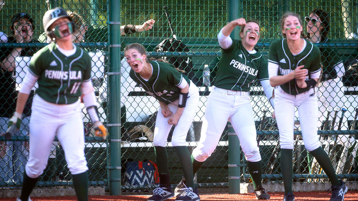 Peninsula’s Malia Coit (from left), Glory Estabrook, Alli Kimball and Grace Estabrook celebrate Hailey Ruckle’s RBI single during Seahawks’ 5-2 victory over the Bonney Lake Panthers in the 3A District 3/4 championship game at the Regional Athletic Complex in Lacey, Washington, on Saturday, May 22, 2022.