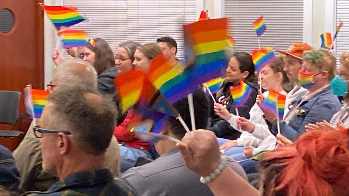 Supporters of a motion to fly the rainbow LGBTQ Pride flag over Fircrest City Hall show their support Tuesday evening during a meeting of the City Council.