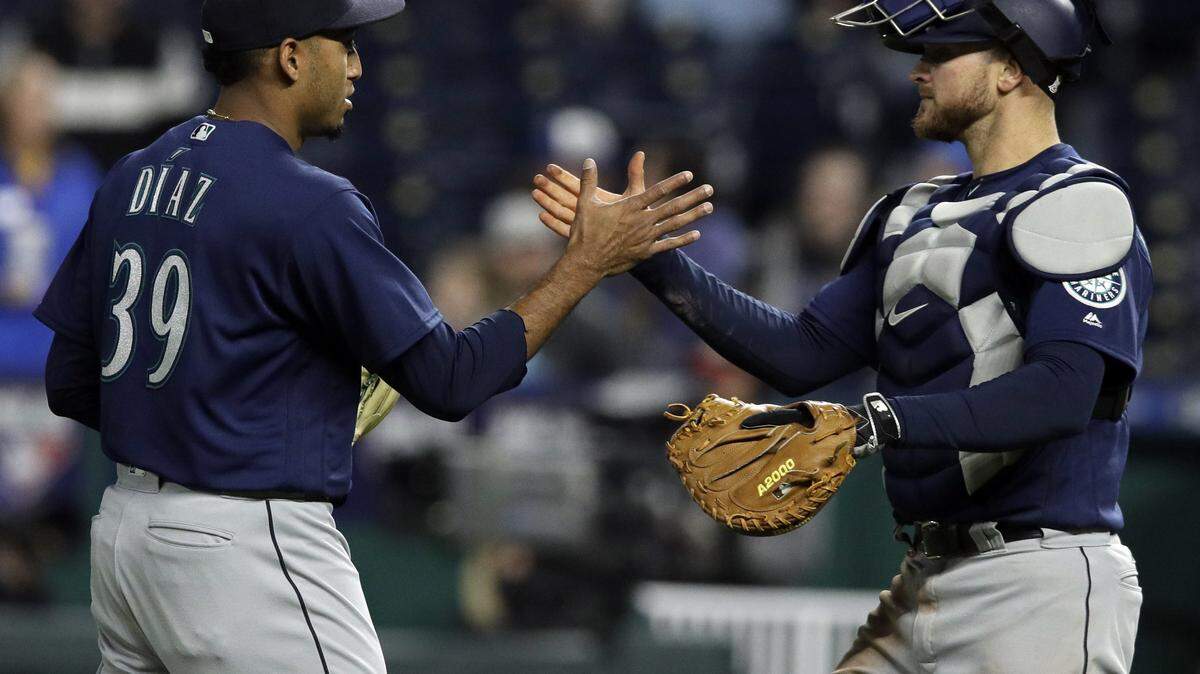 Seattle Mariners relief pitcher Edwin Diaz (39) is congratulated by catcher Mike Marjama, right, following a baseball game against the Kansas City Royals at Kauffman Stadium in Kansas City, Mo., Tuesday, April 10, 2018. The Mariners defeated the Royals 8-3. (AP Photo/Orlin Wagner)