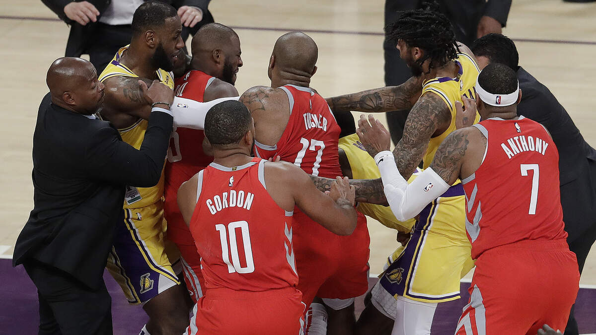 Houston Rockets’ Chris Paul, second from left, is held back by Los Angeles Lakers’ LeBron James, left, as Paul fights with Lakers’ Rajon Rondo, center obscured, during the second half of an NBA basketball game Saturday, Oct. 20, 2018, in Los Angeles. The Rockets won, 124-115. (AP Photo/Marcio Jose Sanchez)