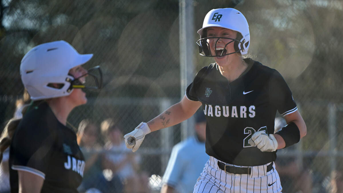 Emerald Ridge’s Abygale Redwine (22) and Emerald Ridge’s Ava Puttler (14) react to scoring two runs against Puyallup in the eighth inning of the softball game at Puyallup High School, on Friday, April 18, 2025, in Puyallup, Wash.