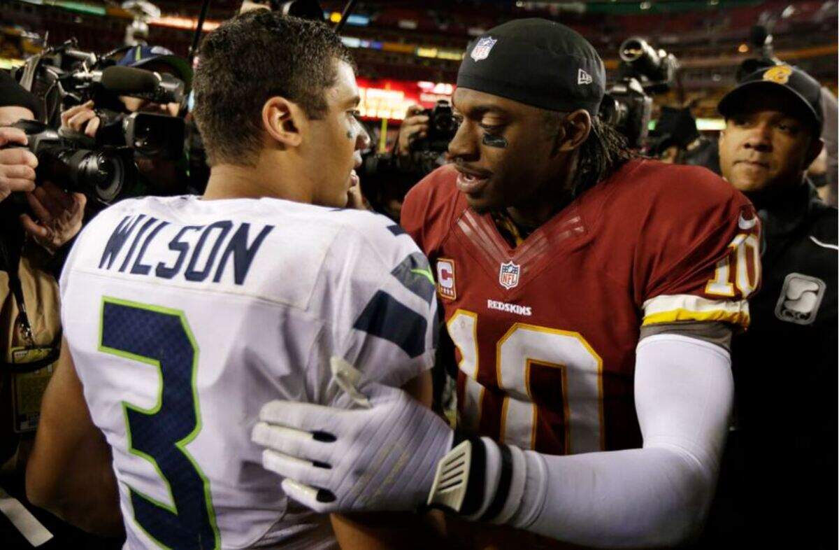 Seahawks rookie quarterback Russell Wilson greets Washington quarterback Robert Griffin III, after Wilson won his first NFL playoff game over Griffin’s team in Landover, Maryland, Jan. 6, 2013. Wilson grew up in Richmond, Viriginia, two hours south of Washington.