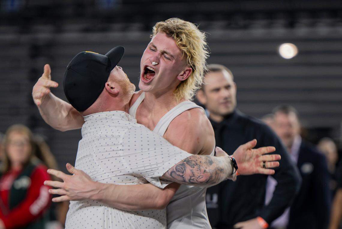 Lincoln’s William Ross embraces father and coach Willie Ross after securing the 126-pound 3A championship during day two of the Mat Classic XXXV at the Tacoma Dome on Saturday, Feb. 17, 2024, in Tacoma, Washington.