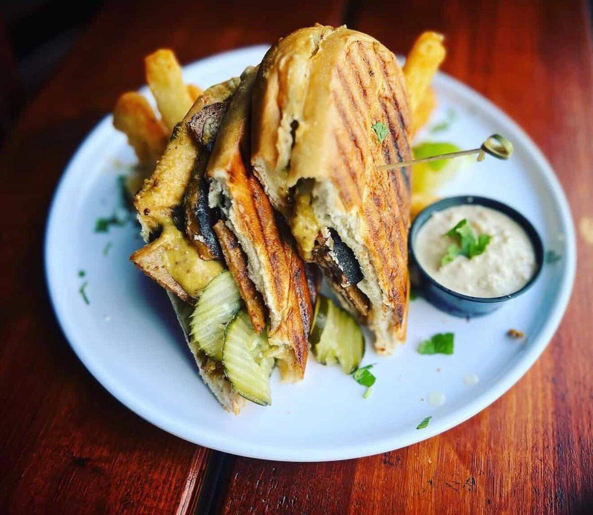 The Vegan Cubano at the Church Cantina, which comes with house made crispy mojo seitan, house made pickle chips, agave stoneground dijon beer mustard on toasty hoagie bread.
