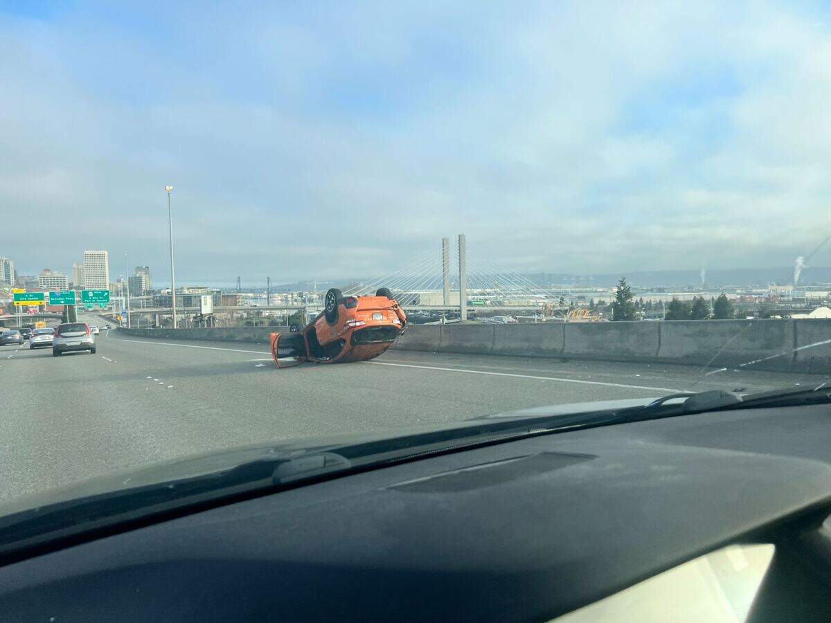 A vehicle has been flipped over on I-705 in Tacoma Monday morning following a hit and run crash.