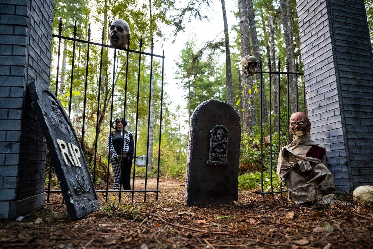 Spooky props and actors dressed in costumes and makeup are hidden in the trees along the mile long trail at My Haunted Forest at Grand Farms in Vaughn, Wash. on Oct. 23, 2022.