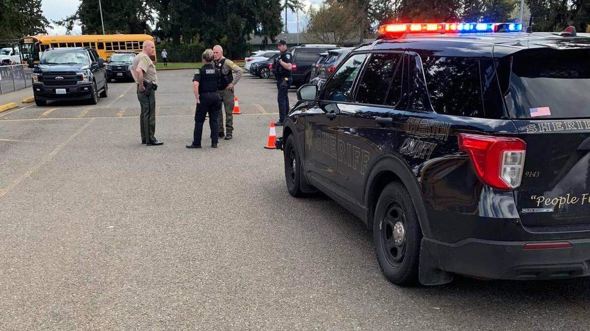 Thurston County sheriff’s deputies investigating a robbery and carjacking in Lacey on Friday.