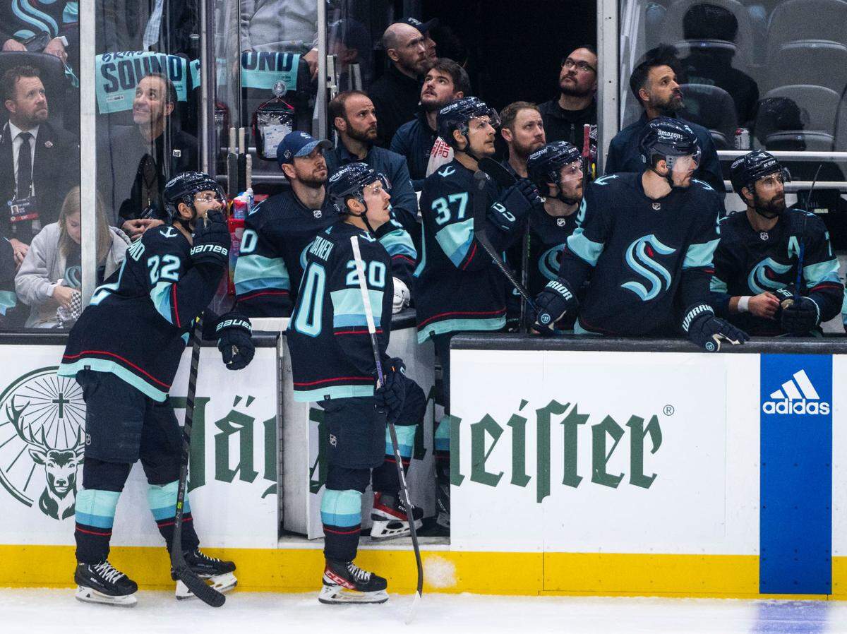 Seattle Kraken players watch a playback of the Dallas Stars scoring a goal on the screen during the second period of game four of the second round of the 2023 Stanley Cup Playoffs against the Dallas Stars in Seattle, Wash. on May 9, 2023.