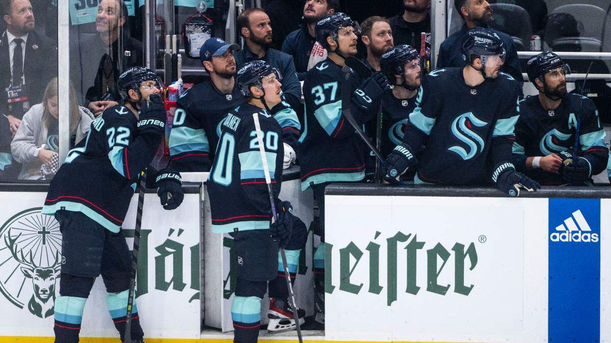 Seattle Kraken players watch a playback of the Dallas Stars scoring a goal on the screen during the second period of game four of the second round of the 2023 Stanley Cup Playoffs against the Dallas Stars in Seattle, Wash. on May 9, 2023.