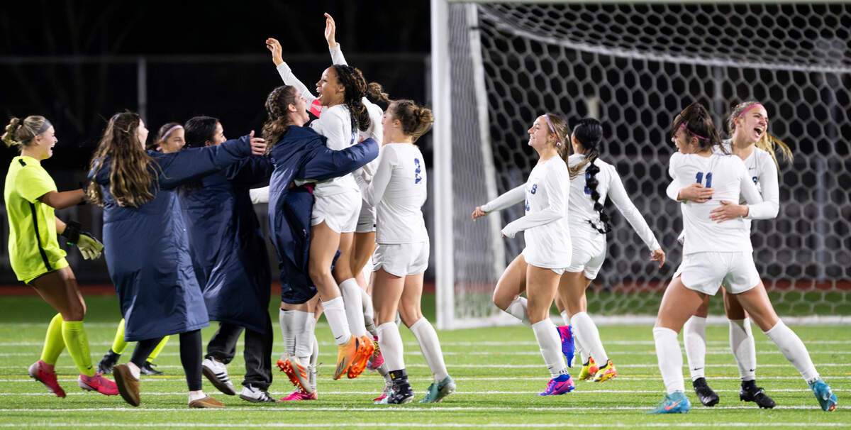 Rogers girls celebrate their 2-1 victory over Puyallup at Sparks Stadium, on Tuesday, Oct. 29, 2024 in Puyallup, Wash.