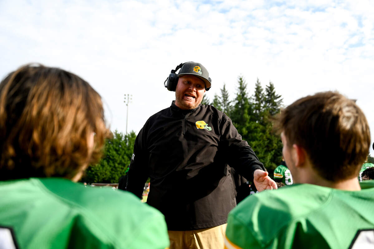 Tumwater head coach Willie Garrow talks to players after a successful drive during the first half of the 2A state quarterfinals against the Clarkston Bantams at Tumwater District Stadium, Saturday, Nov. 18, 2023, in Tumwater, Wash.