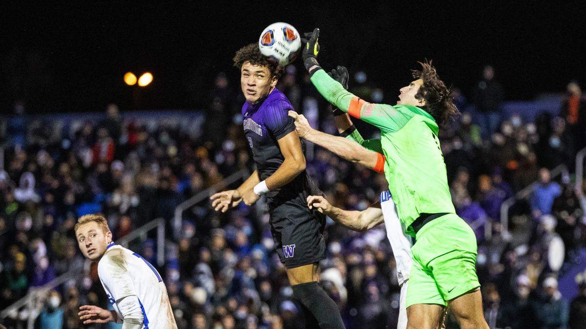 St. Louis goalkeeper Patrick Schulte deflects the header by Washington’s Kendall Burks in the 2nd half. The St. Louis University Billikens played the University of Washington Huskies in NCAA Soccer quarterfinals action Saturday, Dec. 4, 2021 at Husky Soccer Stadium, In Seattle, WA.