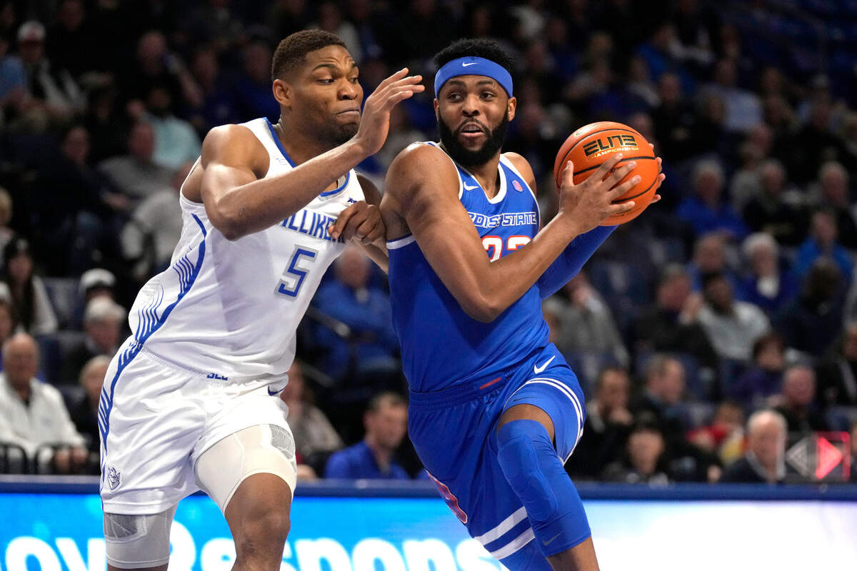 Boise State’s Naje Smith, right, drives to the basket past Saint Louis’ Francis Okoro (5) during the first half of an NCAA college basketball game Saturday, Dec. 10, 2022, in St. Louis. (AP Photo/Jeff Roberson)