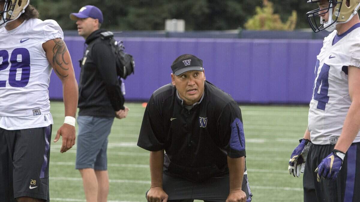 Husky coach Ikaika Malloe watches his players during first day of practice at University of Washington on Monday, Aug. 8, 2016.