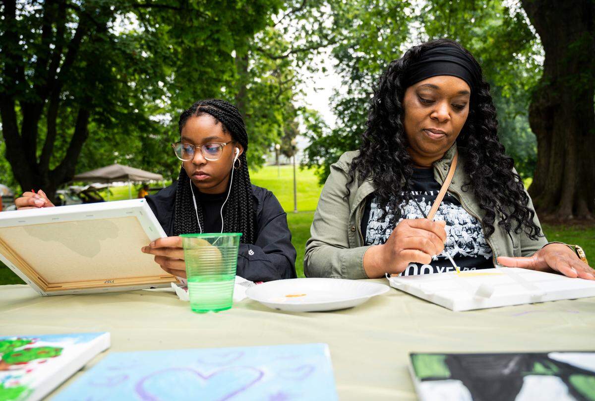 Latisha Conley and her daughter, Larrisa Conley, paint at the third annual Juneteenth celebration at Wright Park in Tacoma, Wash. on Saturday, June 18, 2022.