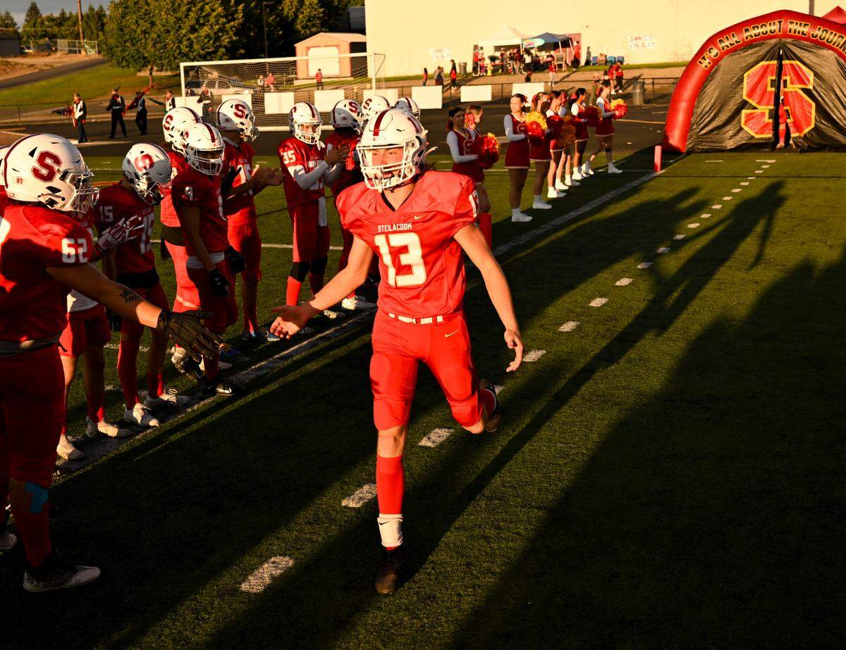 Steilacoom’s Josiah Morley (13) greets teammates while taking to the field before the first half of the football game against White River at Steilacoom High School, Thursday, Sept. 7, 2023, Steilacoom, Wash.