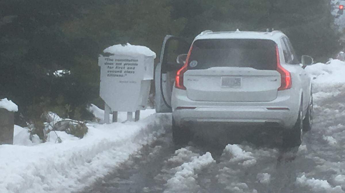 Braving the post-snowstorm mess on Election Day, a Peninsula School District voter uses the ballot drop box on Point Fosdick Drive in Gig Harbor.