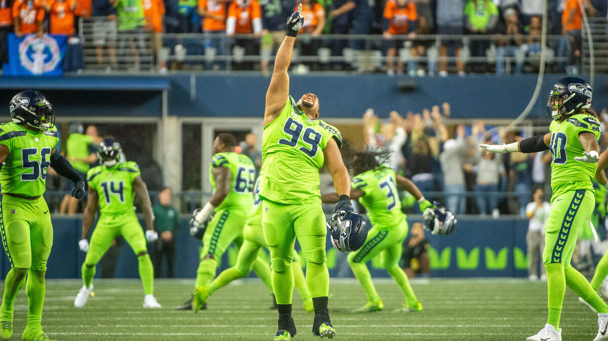 Seattle Seahawks defensive tackle Al Woods (99) celebrates with his teammates after Denver Broncos place kicker Brandon McManus (8) missed a 64-yard field goal with 20 seconds left in the fourth quarter of an NFL game on Monday, Sept. 12, 2022, at Lumen Field in Seattle.