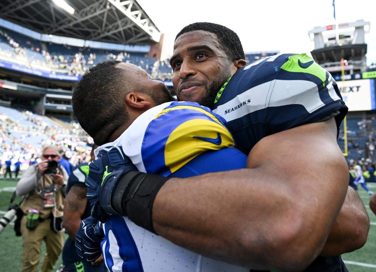 Los Angeles Rams defensive tackle Aaron Donald (99) and Seattle Seahawks linebacker Bobby Wagner (54) hug after Los Angeles Rams 30–13 victory against the Los Angeles Rams at Lumen Field, Sunday, Sept. 10, 2023, Seattle, Wash.