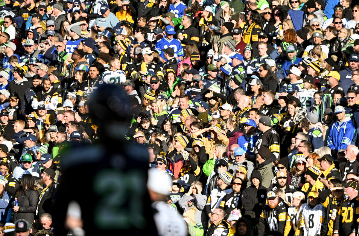 A sea of Pittsburgh Steelers fans watch as Seattle Seahawks cornerback Devon Witherspoon (21) gets a stop during the first quarter of the game at Lumen Field, on Sunday, Dec. 31, 2023, in Seattle, Wash.