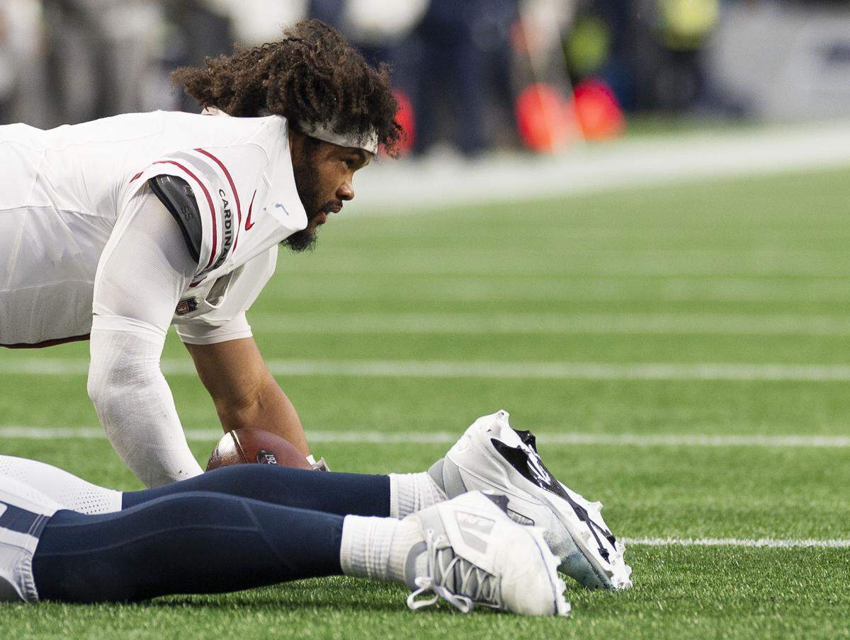 Arizona Cardinals quarterback Kyler Murray (1) picks himself up after a hit from Seattle Seahawks linebacker Ernest Jones IV (13) and defensive end Leonard Williams (99) during the fourth quarter of the game at Lumen Field, on Sunday, Nov. 24, 2024, in Seattle, Wash.