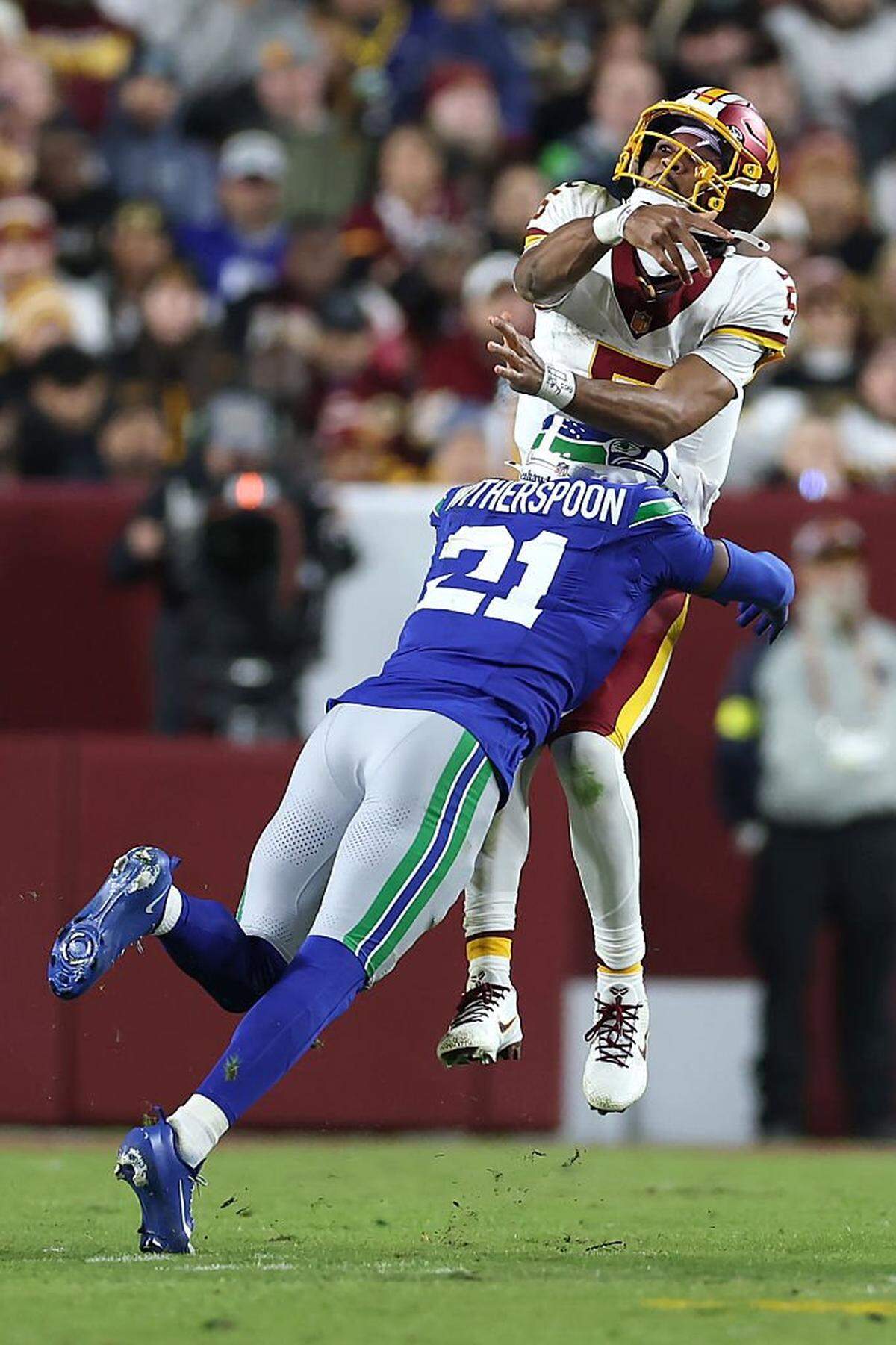 Washington Commanders quarterback Jayden Daniels (5) is hit by Seattle Seahawks cornerback Devon Witherspoon after throwing the ball during the second quarter in the game at Northwest Stadium on November 02, 2025 in Landover, Maryland. (Photo by Scott Taetsch/Getty Images)