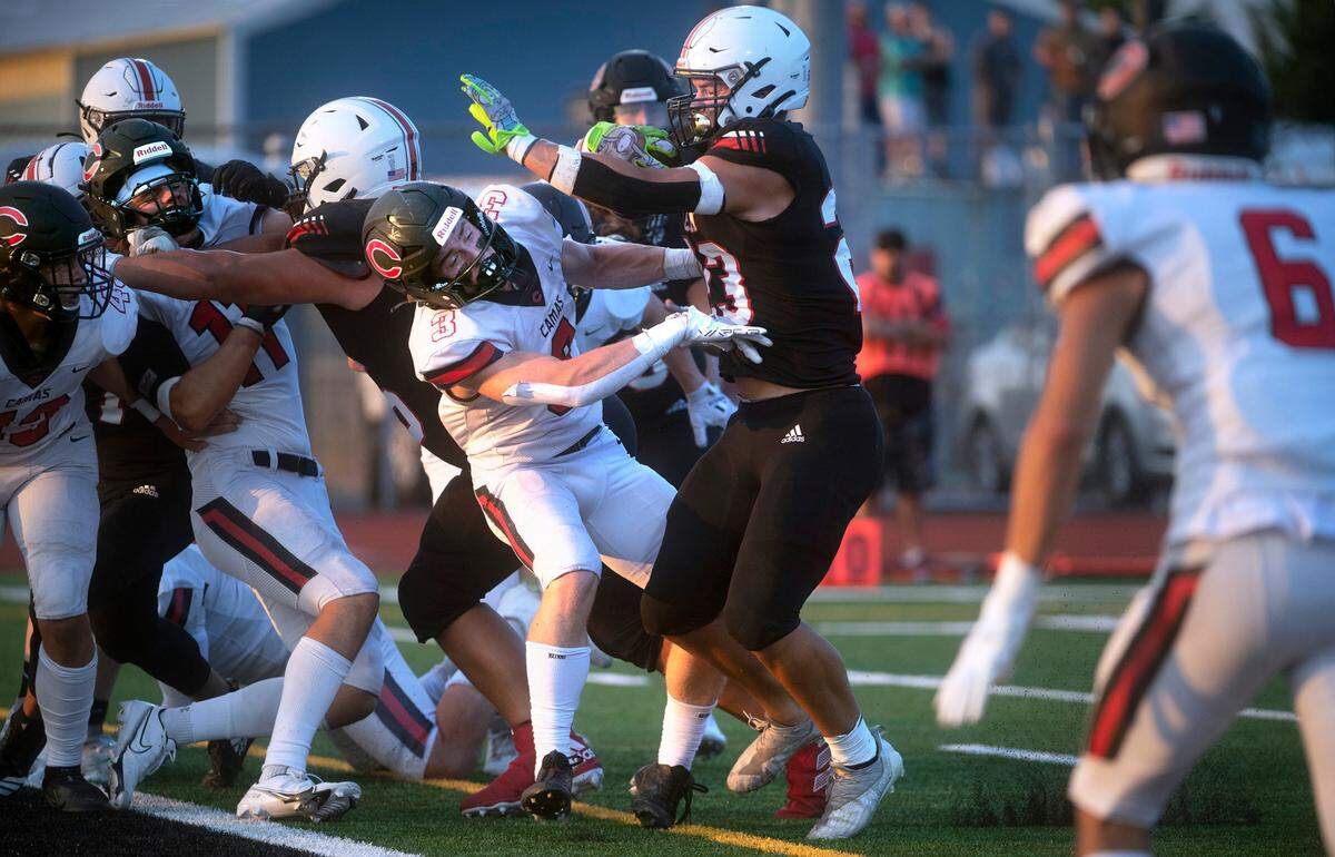Yelm running back Brayden Platt brushes aside Camas defensive back Bradley Prouse to score a two-point conversion during Friday night’s season-opening football game at Yelm High School in Yelm, Washington on Friday, Sept. 2, 2022.