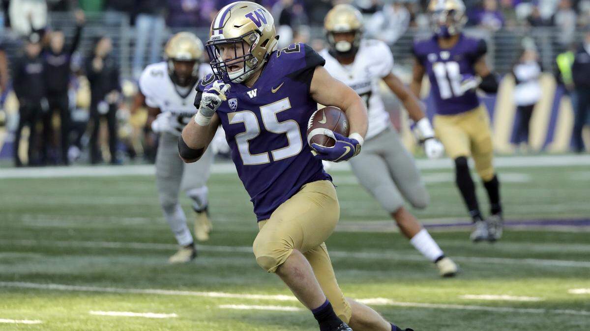 FILE - In this Oct. 20, 2018, file photo, Washington linebacker Ben Burr-Kirven (25) runs after he intercepted a pass thrown by Colorado quarterback Steven Montez during the second half of a game in Seattle. Burr-Kirven was named to the 2018 AP All-America NCAA college football team, Monday, Dec. 10, 2018. (AP Photo/Ted S. Warren, File)
