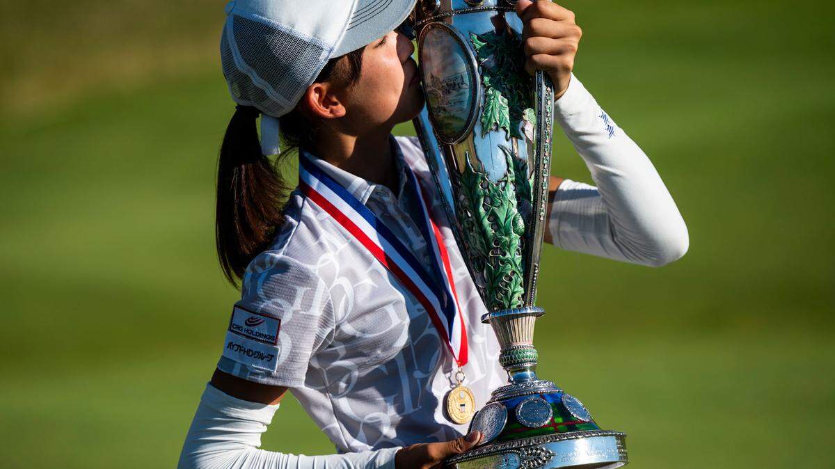 Saki Baba from Japan kisses the USGA Women’s Amateur Championship trophy after winning the122nd U.S. Women’s Amateur Championship on the ninth hole at the Chambers Bay Golf Course in University Place, Wash. on August 14, 2022. Baba secured the win over Monet Chun from Canada by being 10-up and finishing with a birdie on the ninth hole.