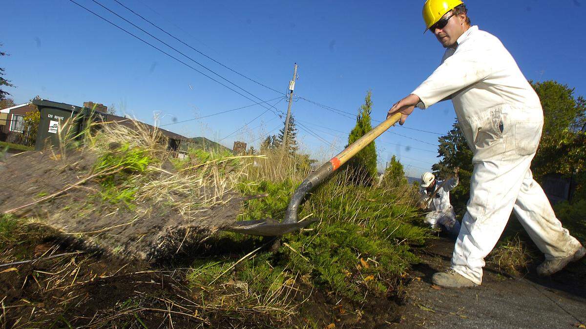 Kevin Thiessen with MRC Construction sends a shovel full of contaminated soil into a pile in front of a  Ruston home at the 4700 block of Mullen Street in Ruston in 2011.