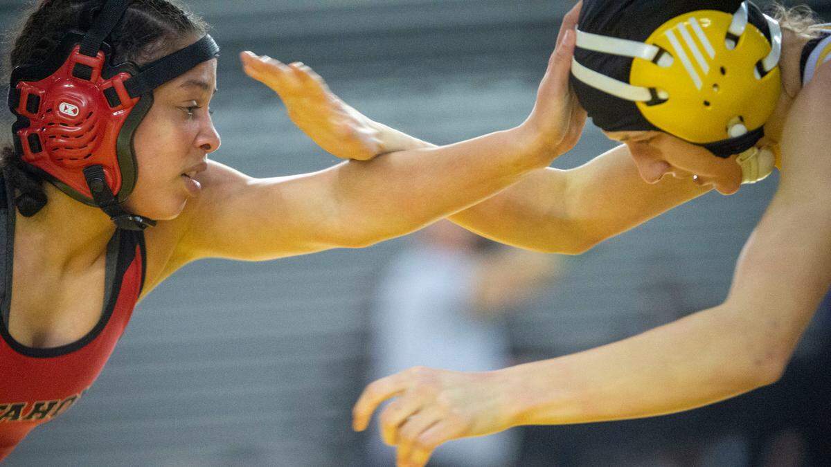 Mount Tahoma’s Zeta Lee and Ellabelle, of Rogers (Spokane) fight for hand position during their 110-pound girls semifinal contest at Mat Classic XXXIII on Saturday, Feb. 19, 2022, at the Tacoma Dome in Tacoma, Wash. Lee won by decision, 5-2.