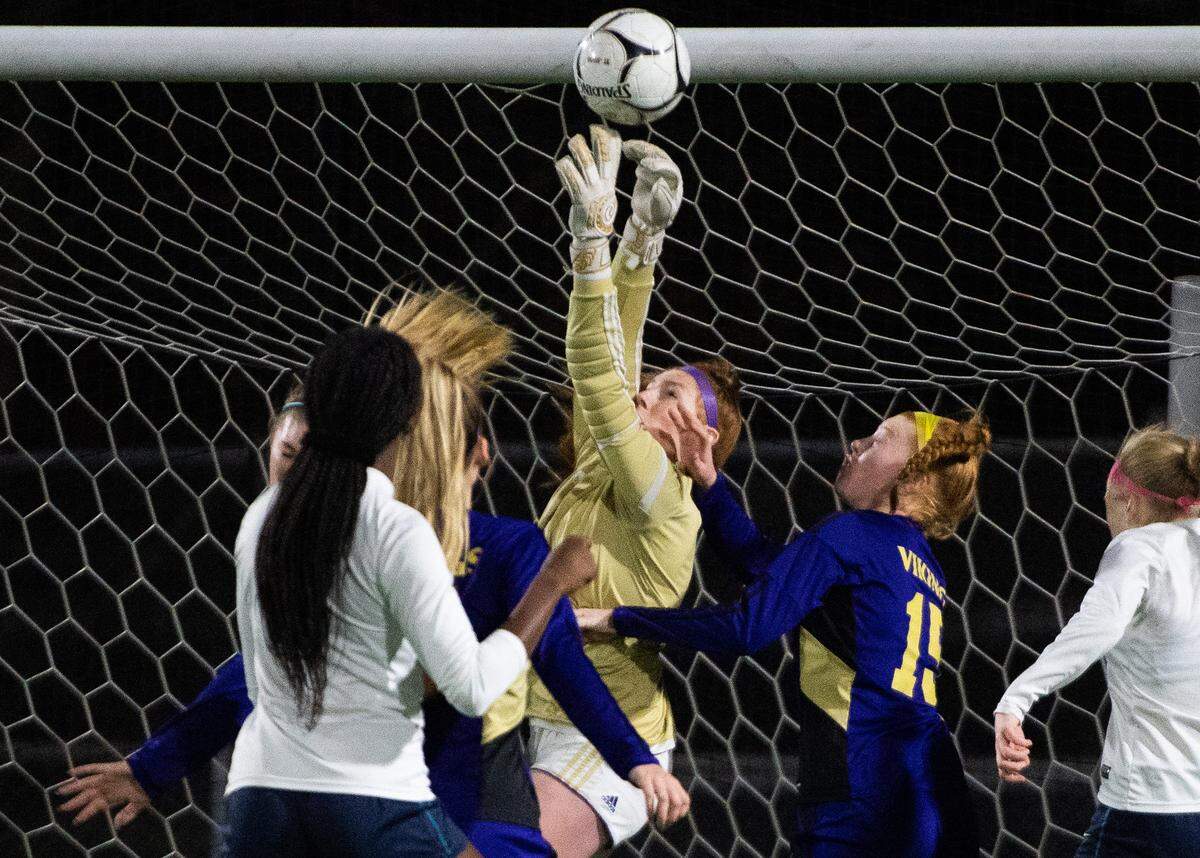 Puyallup’s Ally Larkin leaps for a save during the second half. Puyallup played Auburn Riverside in the WIAA 4A Girls Soccer State Championship game at Sparks Stadium in Puyallup, Wash., on Saturday, Nov. 23, 2019.