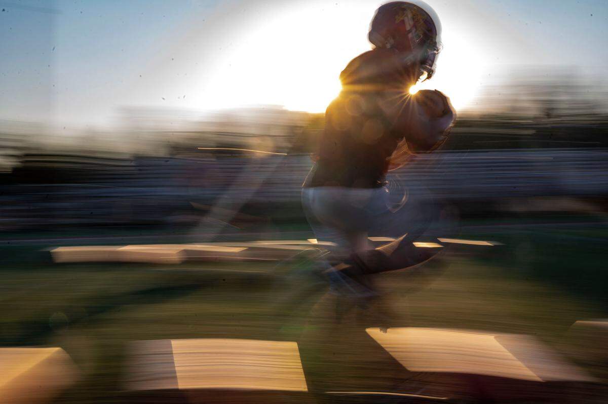Enumclaw running backs run through drills at practice Wednesday, Aug. 24, 2022, in Enumclaw, Wash.