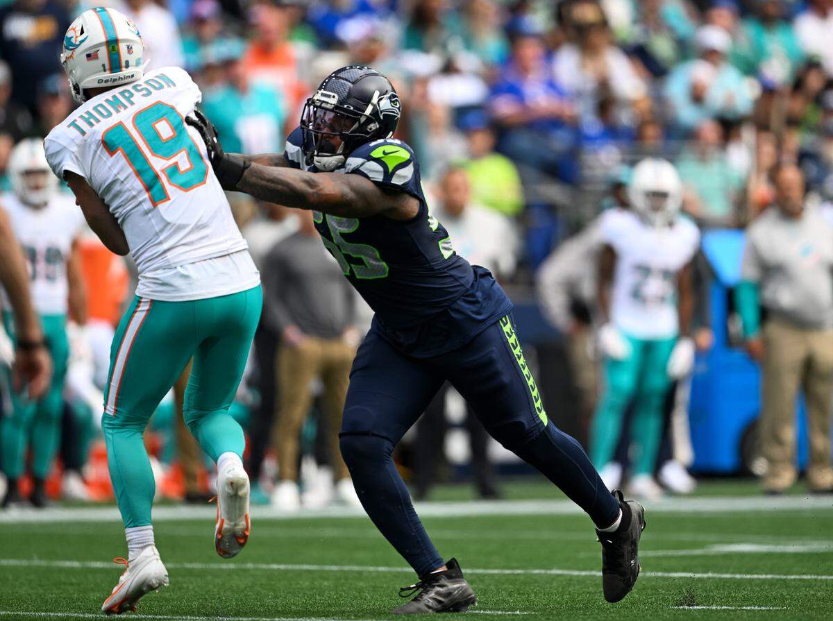 Seattle Seahawks defensive end Dre’Mont Jones (55) hits Miami Dolphins quarterback Skylar Thompson (19) as he throws during the third quarter of the game at Lumen Field, on Sunday, Sept. 22, 2024, in Seattle, Wash. Skylar Thompson was pulled after sustaining an injury in this play.