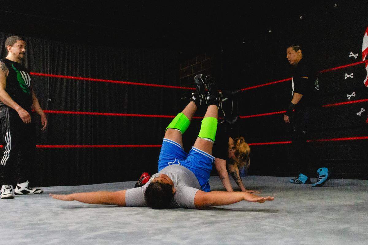 Wrestling students from Lucha Libre Volcanica practice falling flat on their back during their training on Sunday, May 5.
