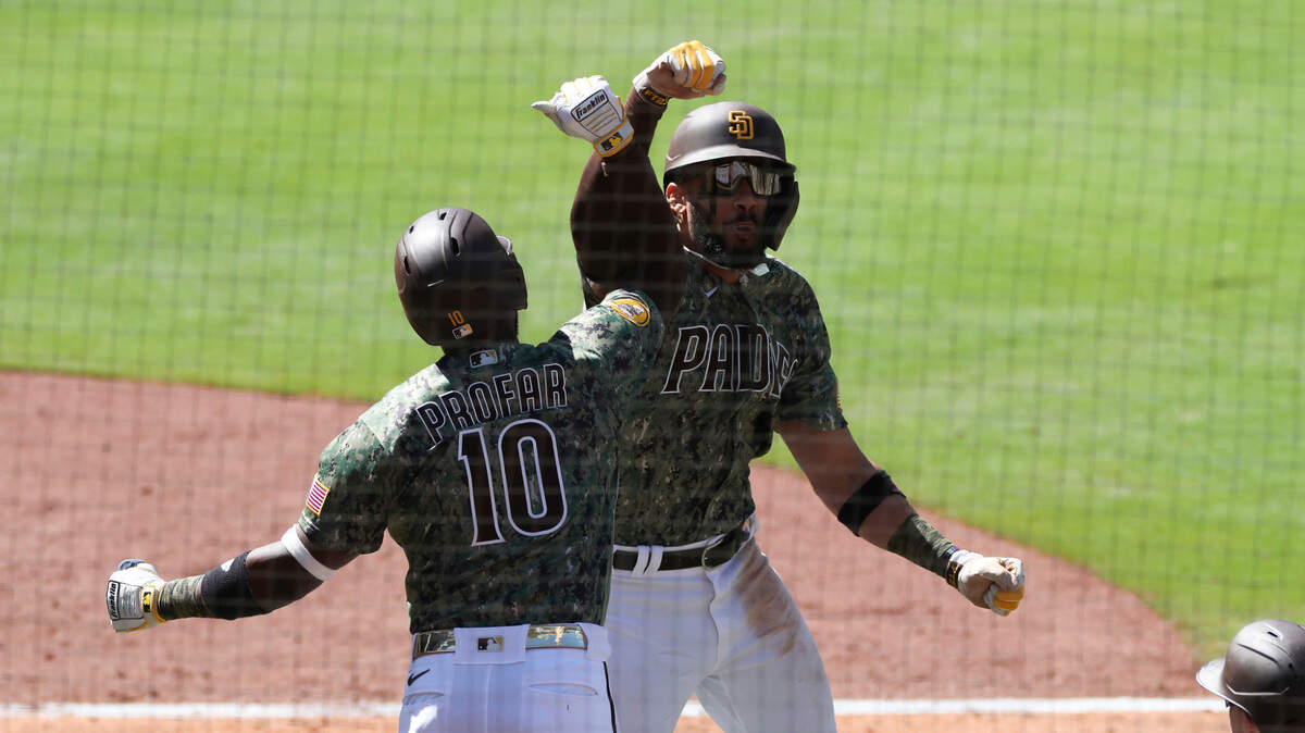 San Diego Padres’ Fernando Tatis Jr., right, celebrates with Jurickson Profar (10) after hitting a grand slam in the seventh inning of a baseball game Sunday, May 23, 2021, in San Diego. (AP Photo/Derrick Tuskan)