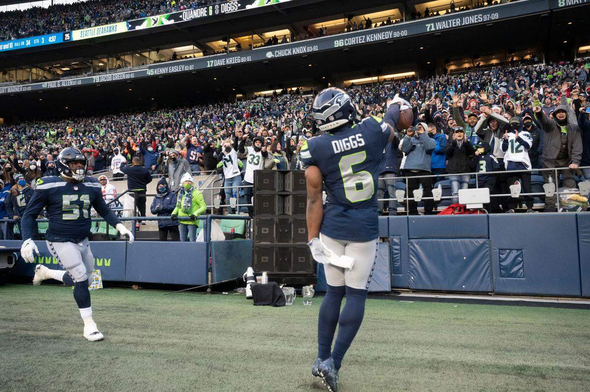 Seahawks fans cheer as Seattle free safety Quandre Diggs (6) celebrates after intercepting a pass by San Francisco 49ers quarterback Jimmy Garoppolo during the third quarter of an NFL game on Sunday at Lumen Field in Seattle.