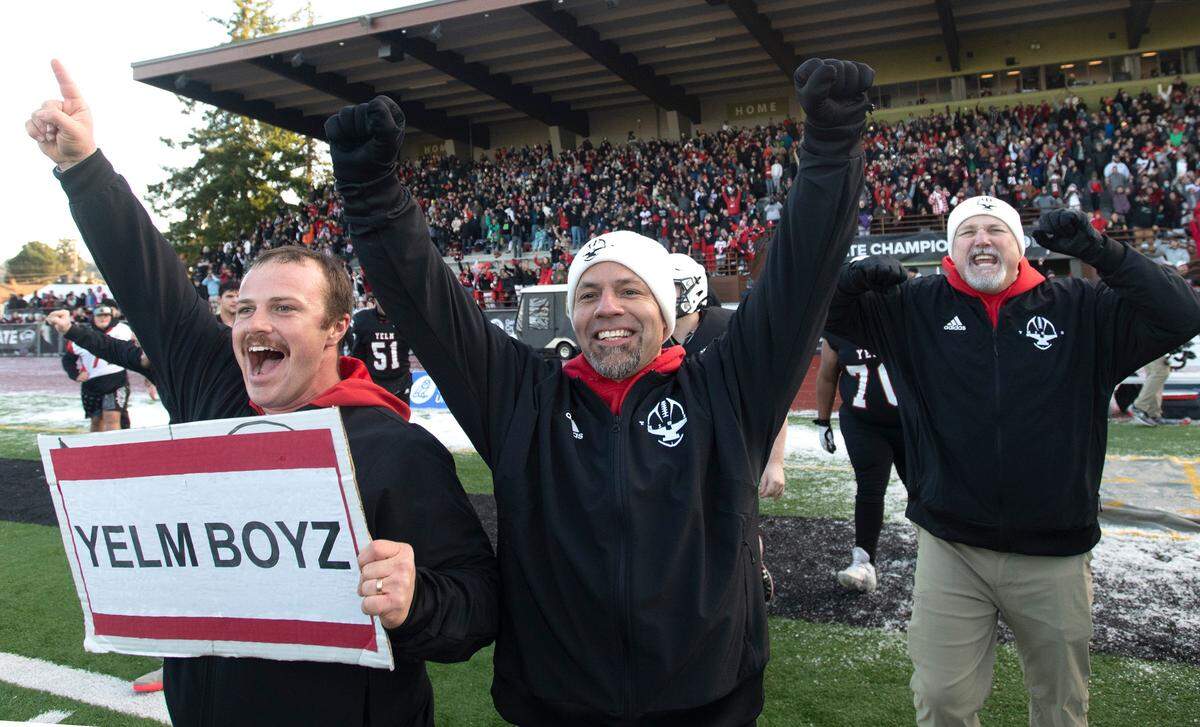 Yelm head coach Jason Ronquillo (center) and his assistants celebrate as the clock expires on the Tornados’ 20-13 victory over the Eastside Catholic Crusaders in the 3A football state championship game at Sparks Stadium in Puyallup, Washington, on Saturday, Dec. 3, 2022.