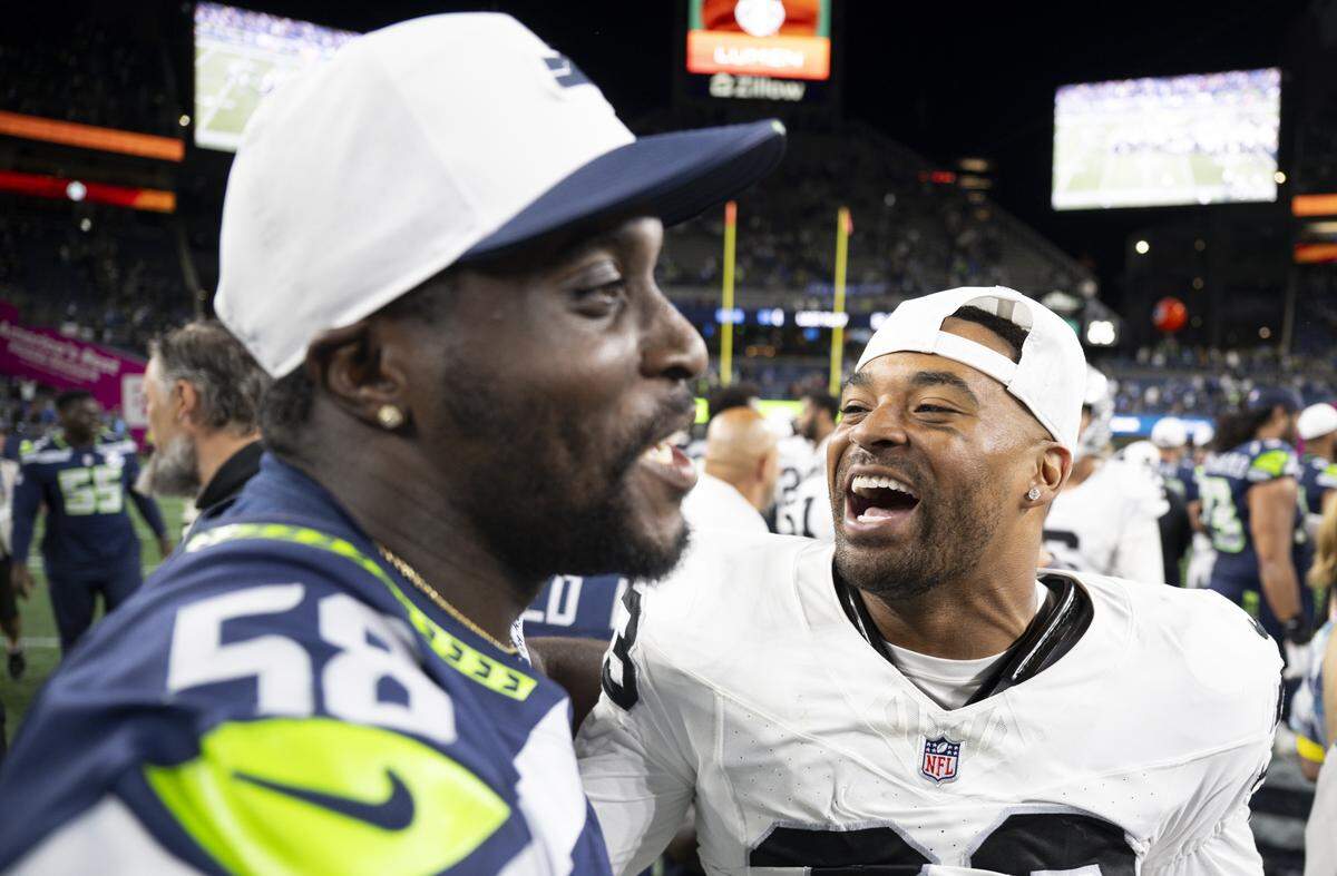 Seattle Seahawks linebacker Derick Hall (58) and Las Vegas Raiders safety Jamal Adams (33) talk after the Seattle Seahawks and Las Vegas Raiders 23-23 game at Lumen Field, on Thursday, Aug. 7, 2025, in Seattle, Wash.