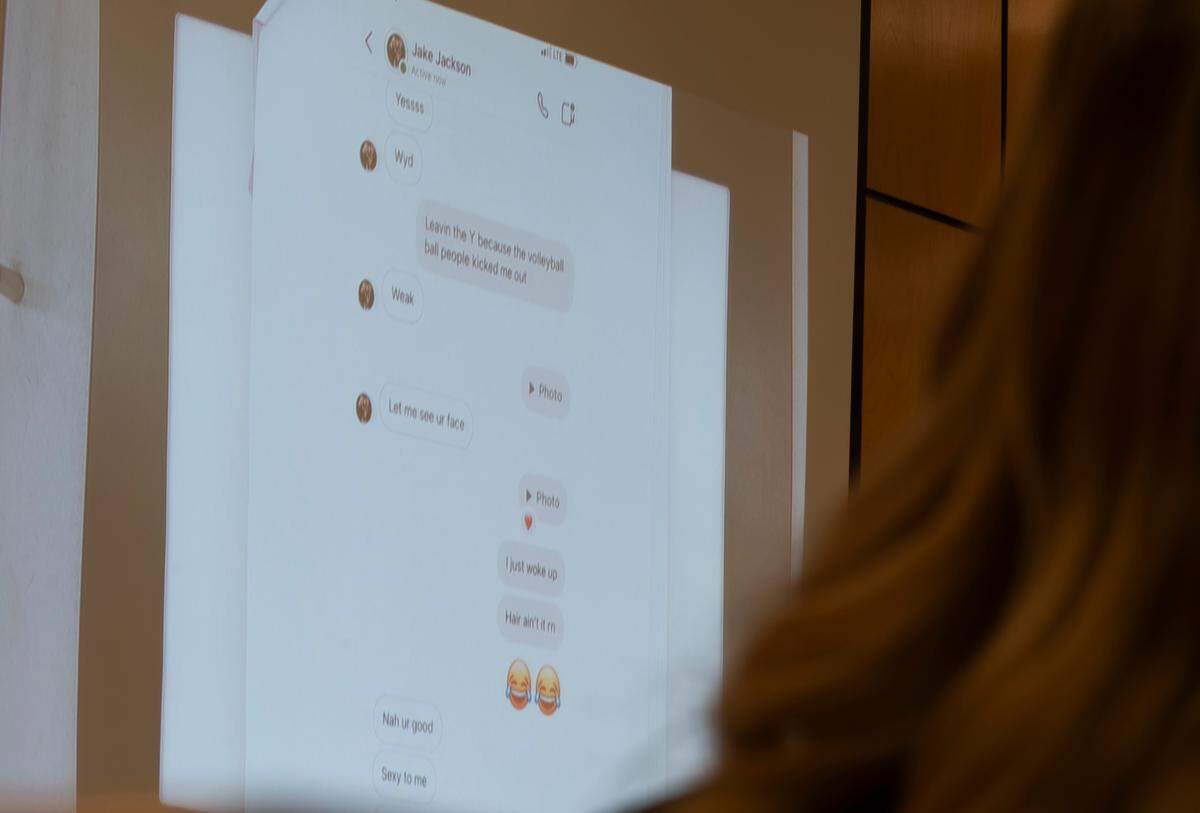 A slide showing direct messages between Jake Jackson and a high school athlete are displayed in court during the trial of Jacob “Jake” Jackson, former Sumner High School coach, for sexual abuse of his players, at Pierce County Superior Court, on Wednesday, Jan. 22, 2025, in Tacoma Wash.